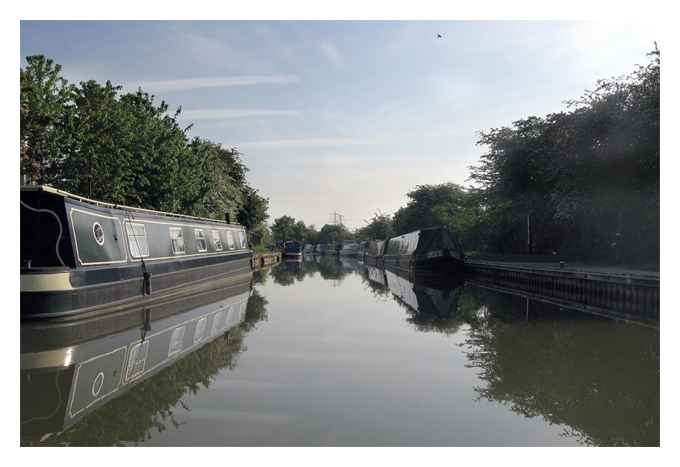 Past the moored narrowboats.